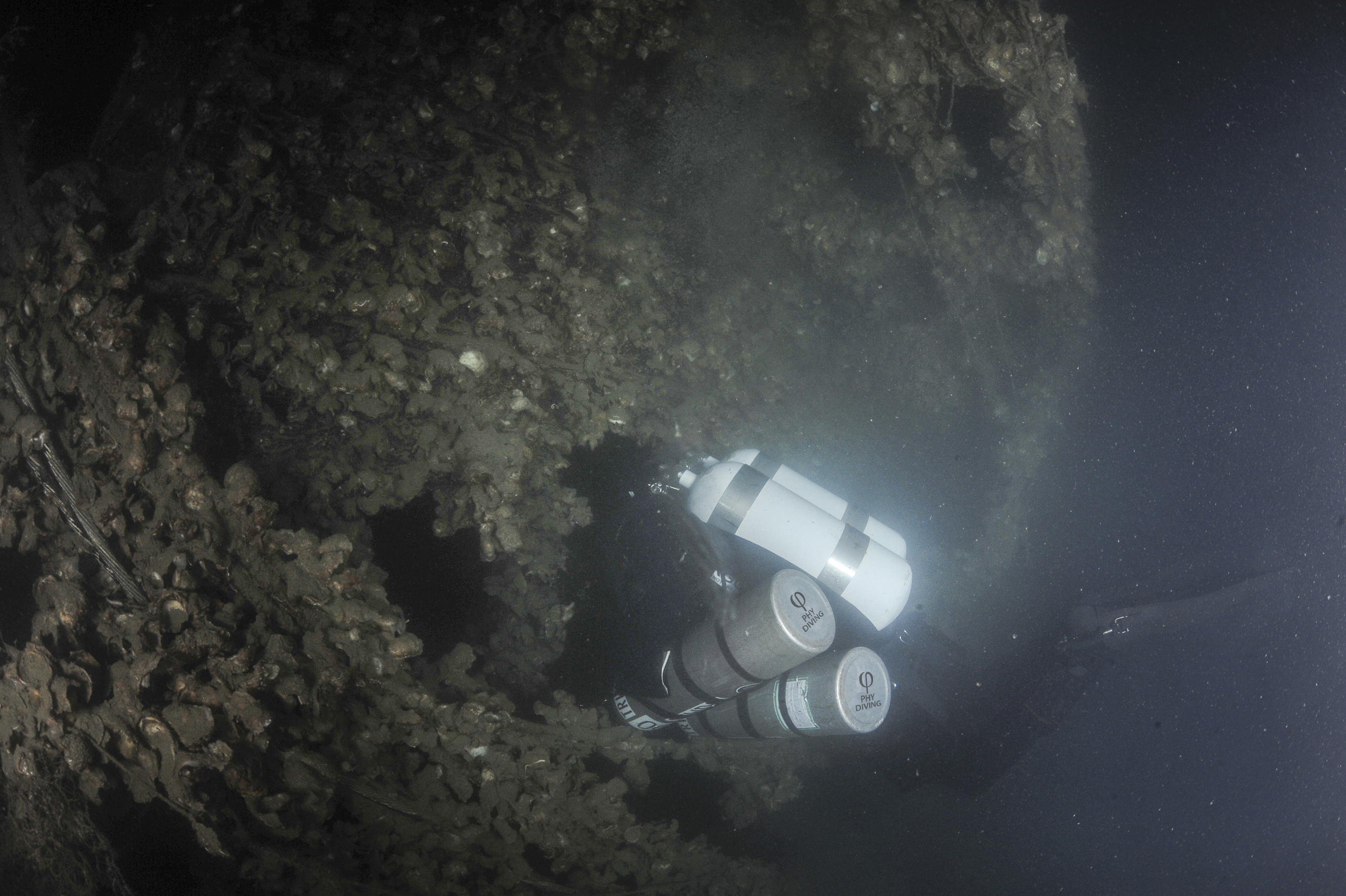 Alpini looking inside the bow deck of the UJ-2208 at 106m. Photo by Marco Mori.